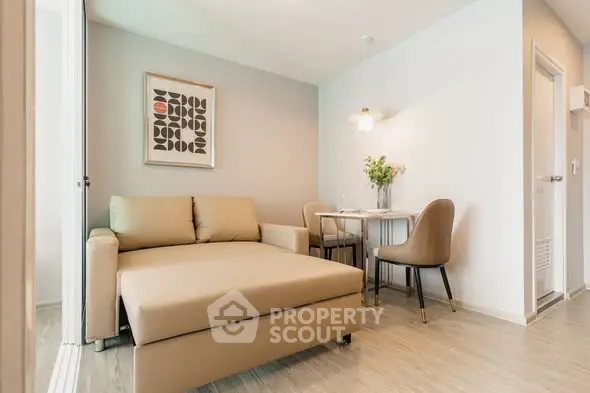 Modern living room with cozy sofa and dining area in stylish apartment.