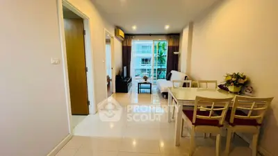 Spacious modern living room with dining area and large windows offering natural light.