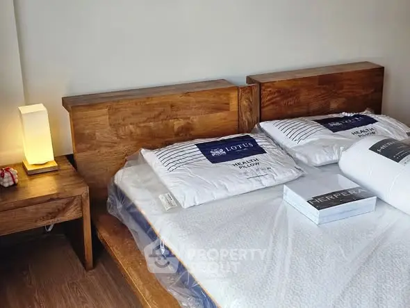 Cozy bedroom with wooden furniture and soft lighting for a relaxing ambiance.