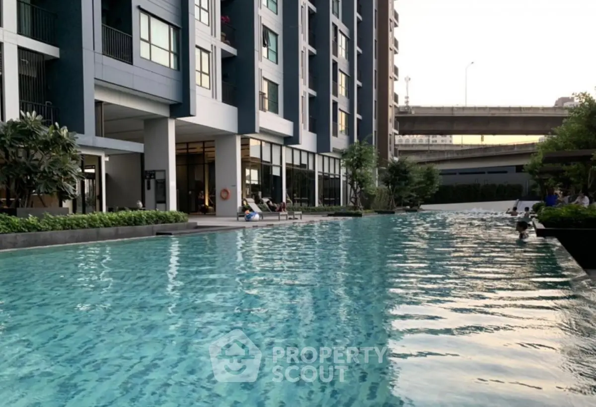 Luxurious condominium with a stunning outdoor pool and modern architecture, perfect for relaxation and leisure.
