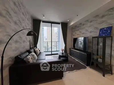 Modern living room with stylish decor and city view from large windows.