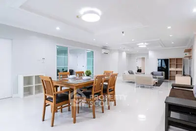 Spacious modern living and dining area with elegant furnishings and bright lighting.