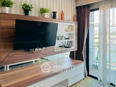 Modern living room with wall-mounted TV and balcony access, featuring stylish decor and natural light.