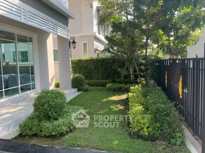 Charming garden view of modern home with lush greenery and elegant exterior design.