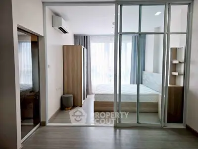 Modern bedroom with glass partition and natural light in stylish apartment