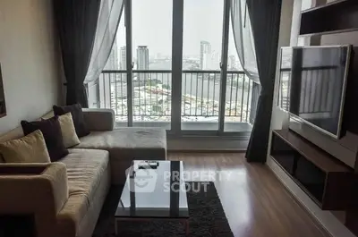 Modern living room with city view, featuring sleek furniture and large windows for natural light.