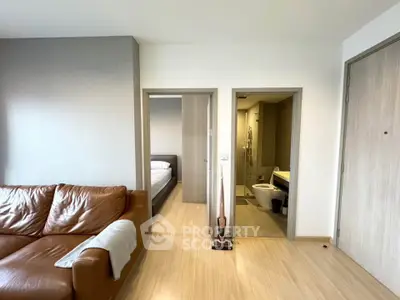 Modern apartment interior with cozy living room and adjacent bedroom and bathroom.