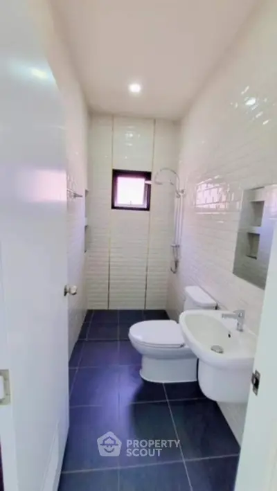 Modern bathroom with sleek white fixtures and stylish tile design