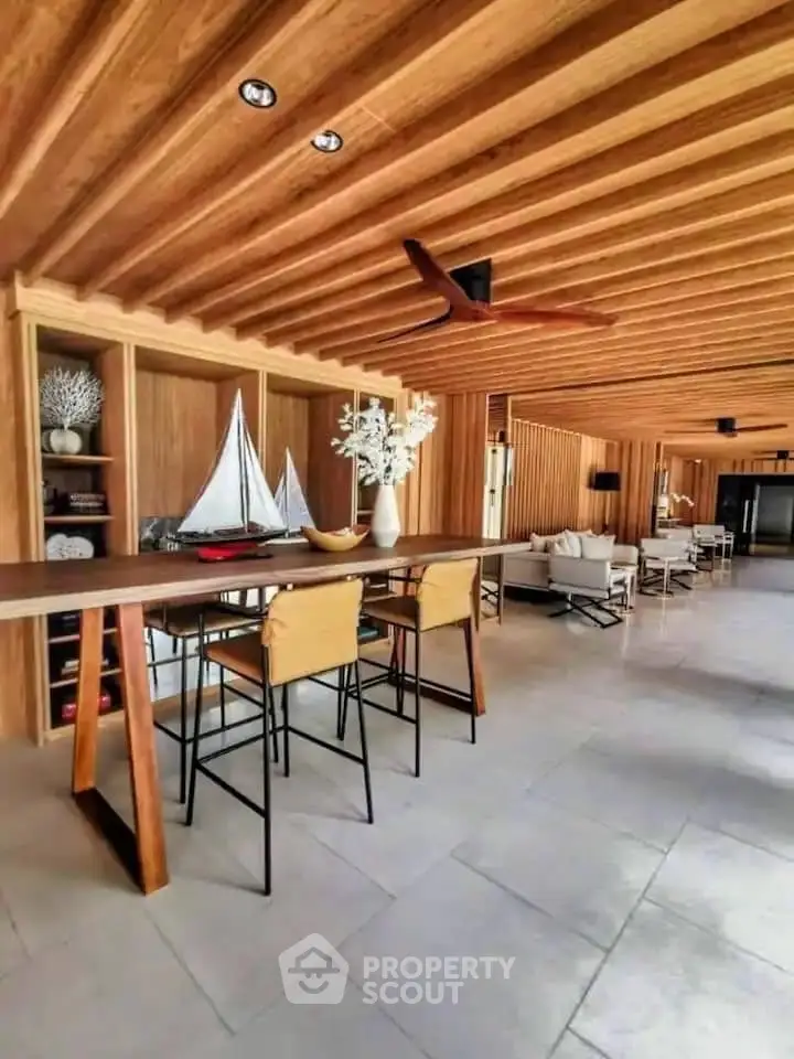 Stunning open-plan living area with wooden ceiling and modern decor