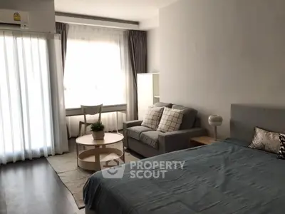 Modern studio apartment with cozy living area and natural light