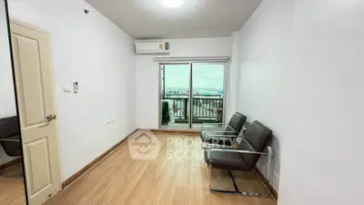 Modern apartment with balcony and air conditioning, featuring sleek chairs and wooden flooring.