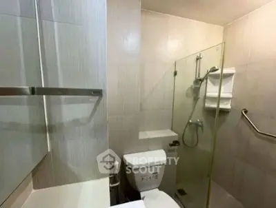 Compact modern bathroom with glass shower and sleek fixtures