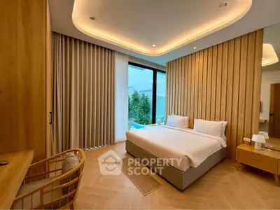 Luxurious modern bedroom with elegant wood accents and large window view.
