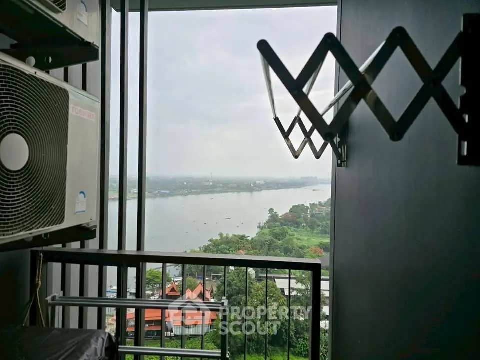 Stunning river view from a high-rise balcony with modern amenities.