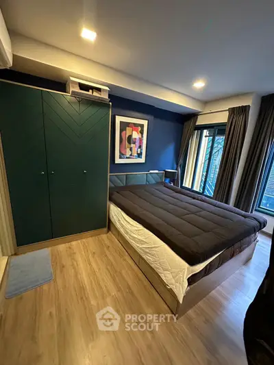 Modern bedroom with stylish decor and large windows for natural light