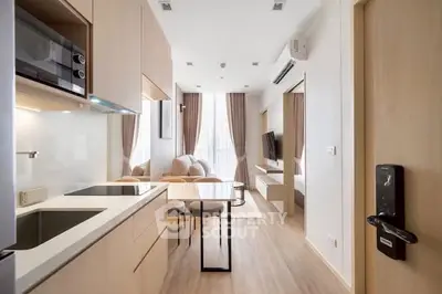 Modern open-layout kitchen and living room with sleek design and natural light.