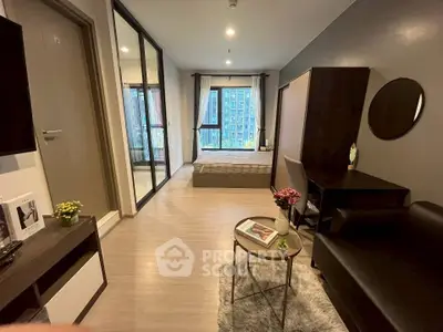 Modern studio apartment with stylish decor and large windows offering city views.