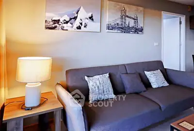 Modern living room with stylish sofa and wall art, perfect for relaxation.