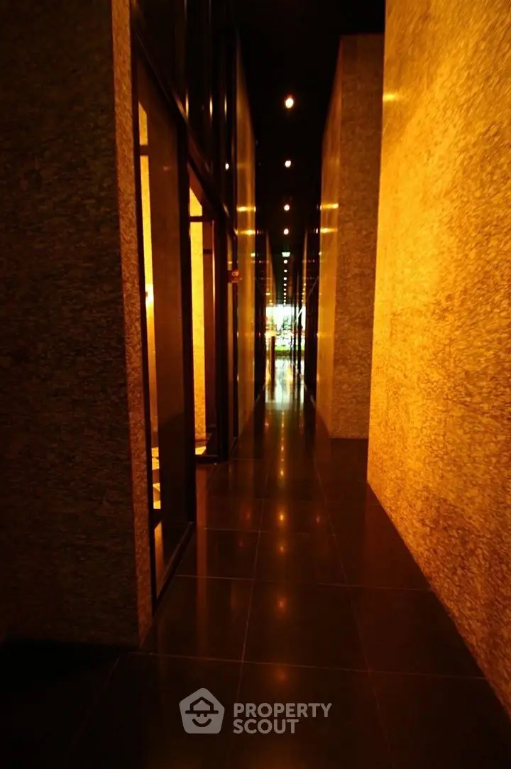 Luxurious hallway with elegant lighting and polished stone walls