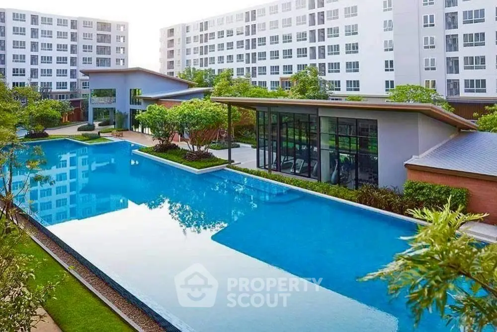 Luxurious condominium complex with stunning pool and modern architecture, perfect for urban living.