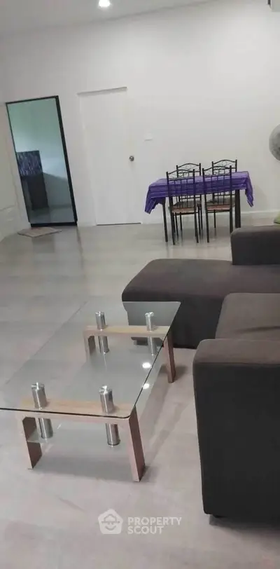 Spacious living room with modern furniture and glass coffee table