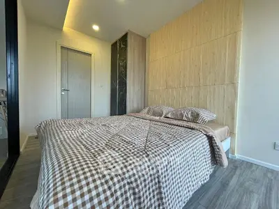 Modern bedroom with stylish wooden accents and cozy checkered bedding