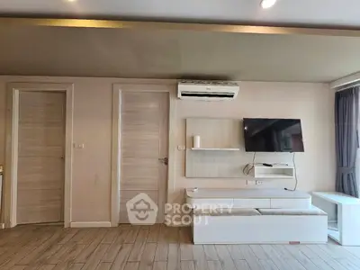 Modern living room with sleek TV setup and air conditioning unit