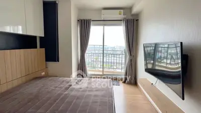 Modern bedroom with balcony and city view, featuring wall-mounted TV and air conditioning.