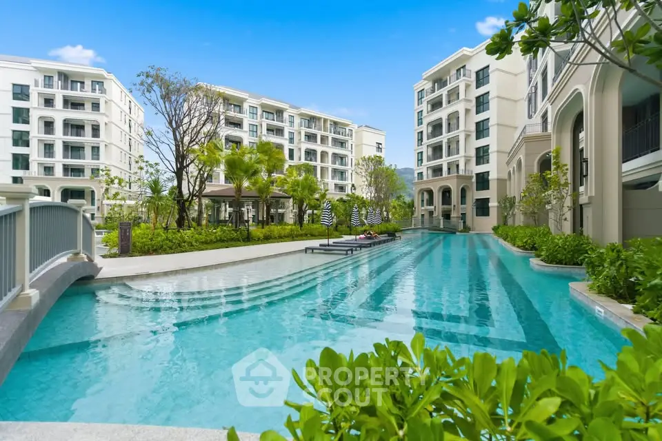Luxurious residential complex with a stunning outdoor pool and lush greenery, perfect for relaxation.