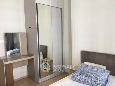 Cozy bedroom with modern wardrobe and stylish vanity in a minimalist design.