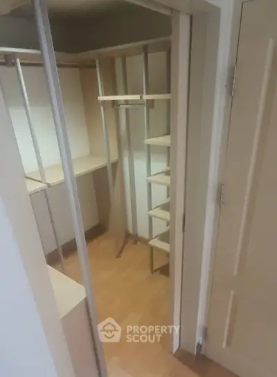 Spacious walk-in closet with custom shelving, perfect for organized storage in a modern home.