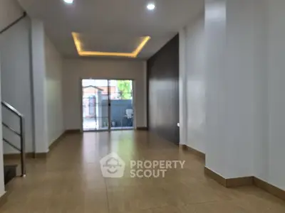 Spacious modern living room with wooden flooring and large windows