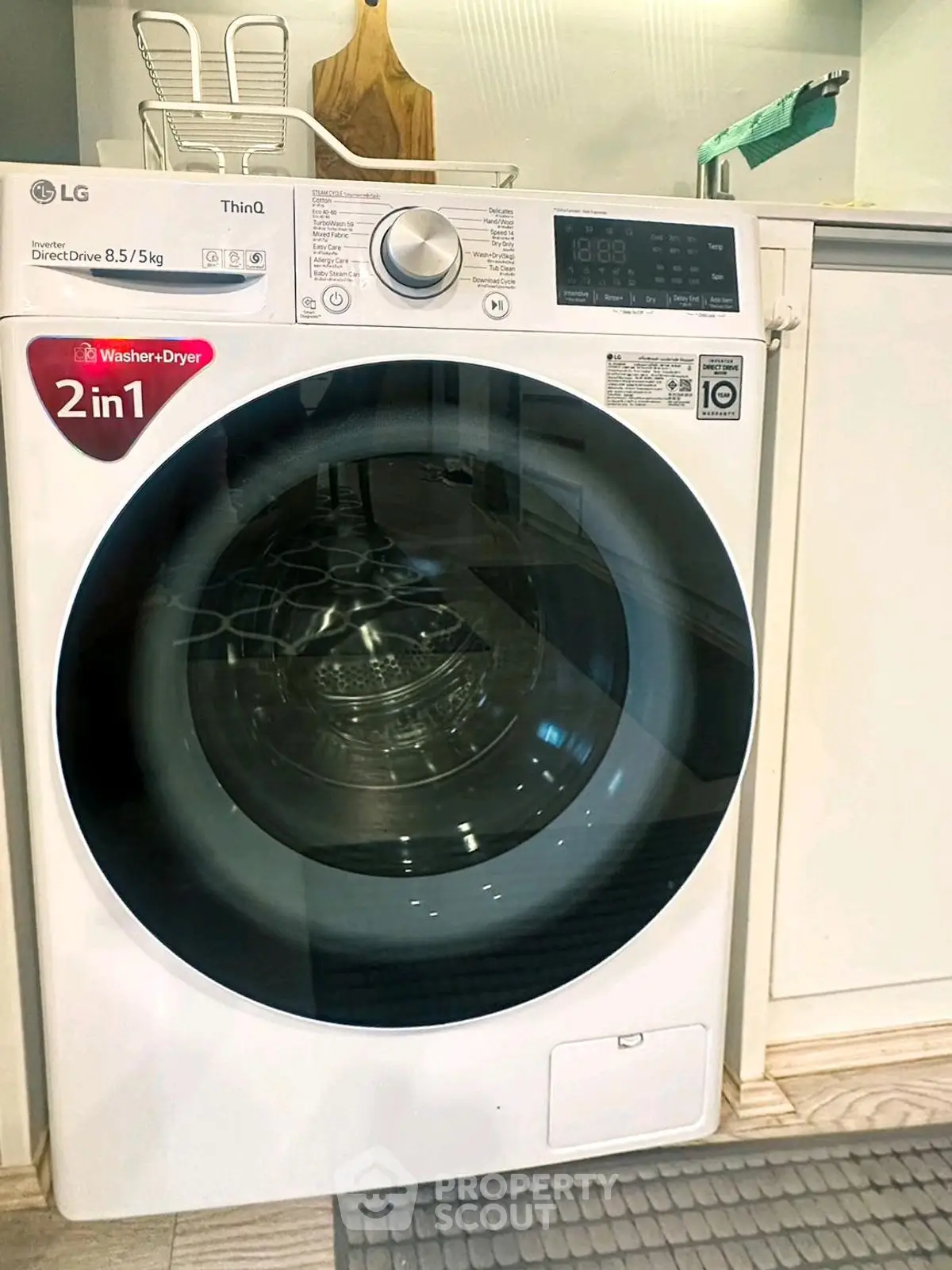 Modern LG washer-dryer combo in sleek laundry area with stylish design.