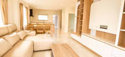Spacious modern living room with open layout and elegant wooden furniture.
