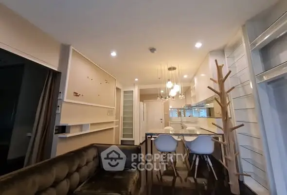 Modern open-layout living room with stylish kitchen and elegant lighting