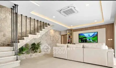 Luxurious living room with modern staircase and built-in entertainment center.