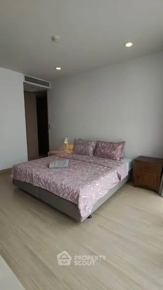 Spacious bedroom with elegant decor and natural light
