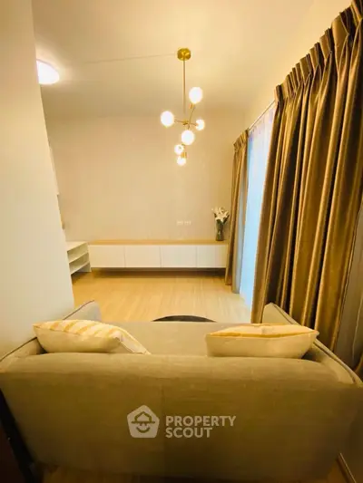 Elegant living room with modern lighting and cozy sofa, perfect for relaxation.