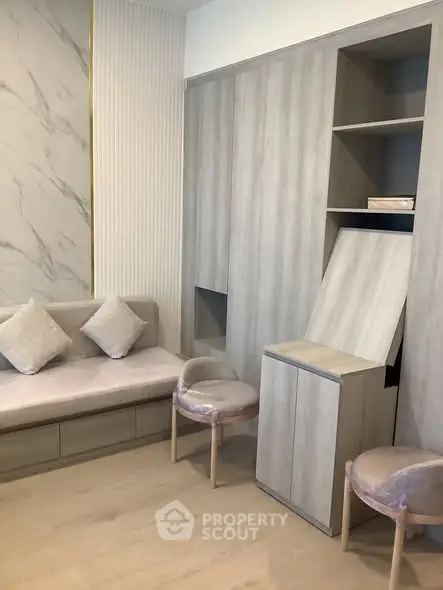 Modern living room with sleek built-in storage and cozy seating area.