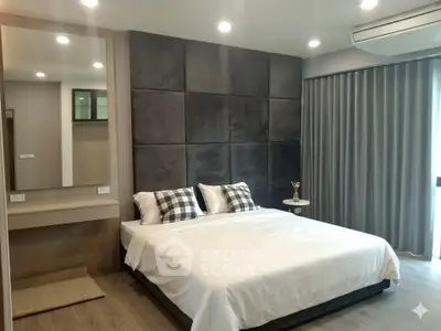 Modern bedroom with stylish decor and large bed in a contemporary apartment.
