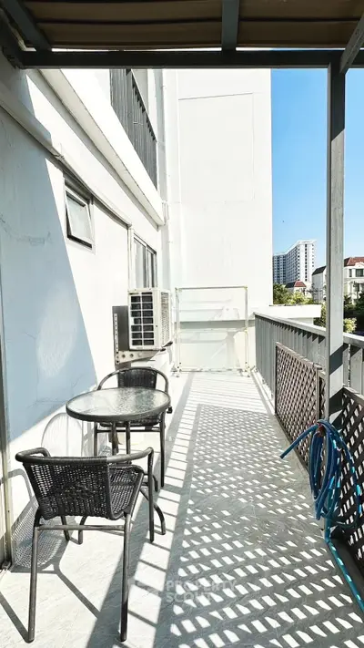 Spacious balcony with outdoor seating and city view, perfect for relaxation and entertainment.