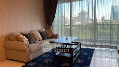 Elegant living room with city view, featuring plush sofa and stylish coffee table.