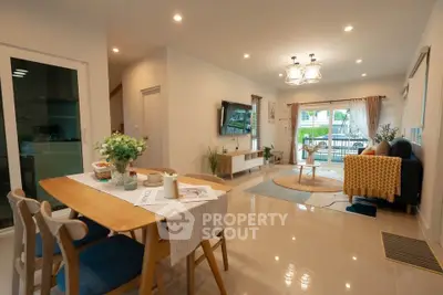 Spacious modern living room with elegant dining area and large windows