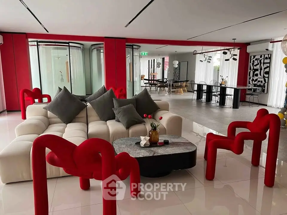 Luxurious modern living room with unique red chairs and elegant decor