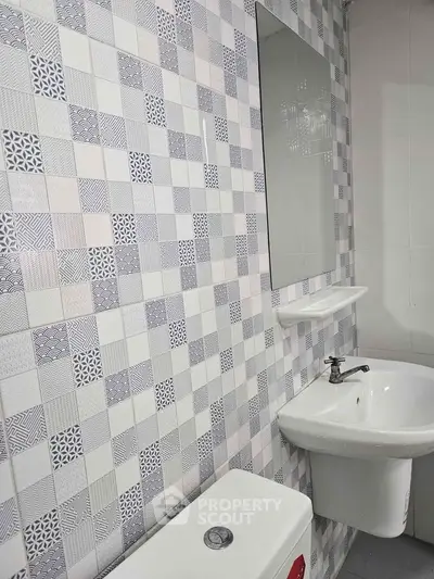 Modern bathroom with stylish tile design and sleek fixtures.