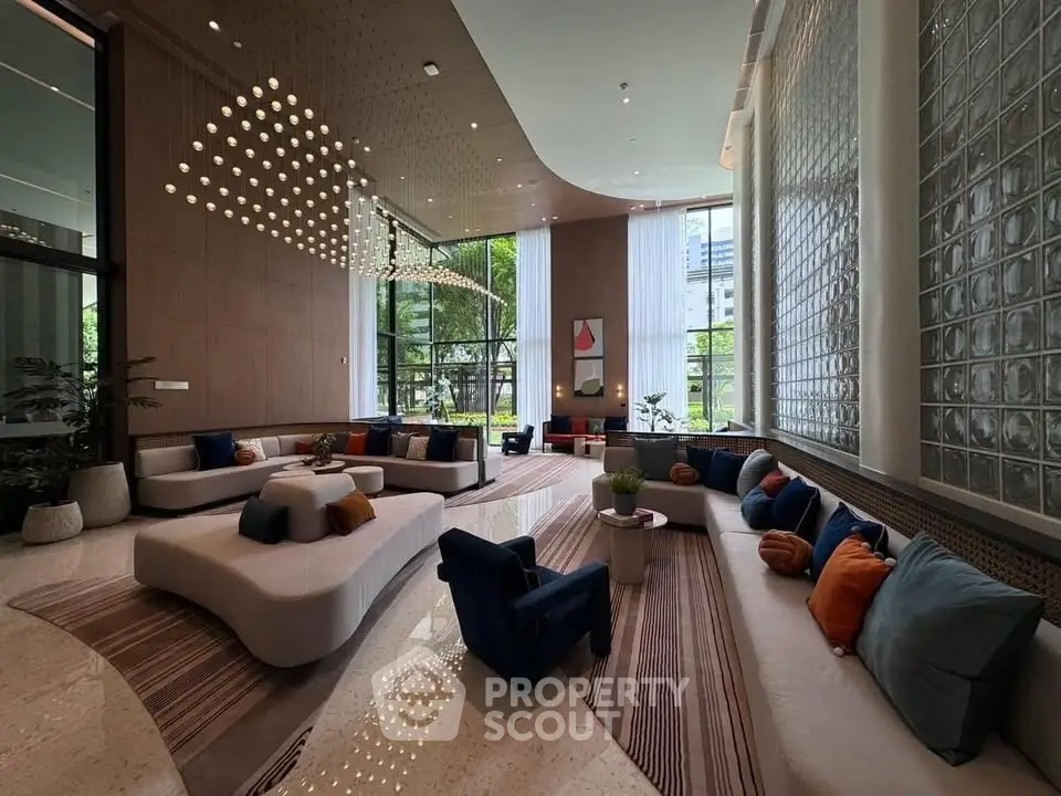 Luxurious modern living room with elegant decor and large windows offering natural light.