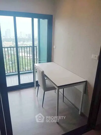 Modern study room with balcony view in high-rise apartment