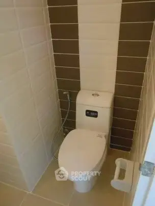 Modern bathroom with sleek toilet and stylish tile design.