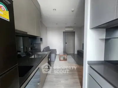 Modern open-layout kitchen and living room with sleek design and neutral tones.