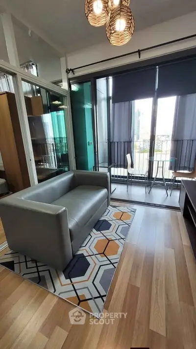 Modern living room with stylish decor and balcony view in urban apartment